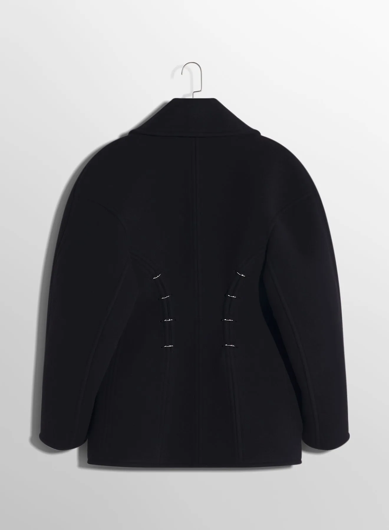 black pierced wool coat